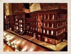 Brooklyn-based blogger Renee Bauman has taken the classic gingerbread house to an awesome new level. She, along with some amateur baker volunteers, has built an entire illuminated gingerbread block of brownstones -- complete with fire escapes and candy glass.