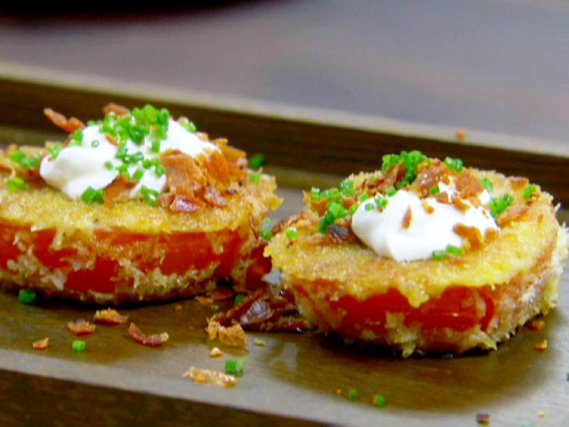 Fried red tomatoes topped with sour cream, prosciutto, and chives.