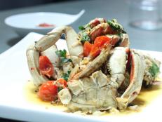Cooking Channel serves up this Whole Roasted Dungeness Crab, Mint, Parsley and Oven-Roasted Tomatoes recipe from Michael Symon plus many other recipes at CookingChannelTV.com