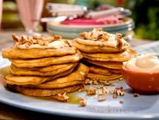 Cooking Channel serves up this Carrot Cake Pancakes with Maple-Cream Cheese Drizzle and Toasted Pecans recipe from Bobby Flay plus many other recipes at CookingChannelTV.com