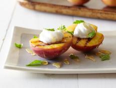 Cooking Channel serves up this Grilled Peaches with Honey, Yogurt and Mint recipe from Michael Symon plus many other recipes at CookingChannelTV.com