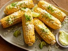 Cooking Channel serves up this Grilled Corn on the Cob with Garlic Butter, Fresh Lime and Cotija Cheese recipe from Bobby Flay plus many other recipes at CookingChannelTV.com