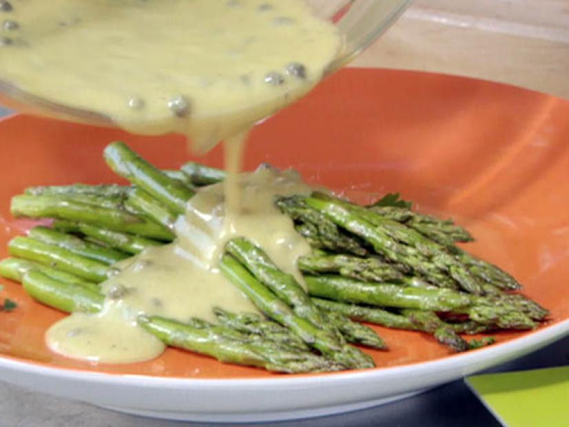 Frame 110
Bobby Flay's grilled asparagus side dish is topped with homemade vinaigrette dressing. The side dish complements Flay's elegant dinner on the grill. 