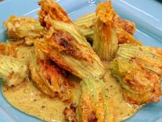 Cooking Channel serves up this Crispy Squash Blossoms Filled with Pulled Pork and Ricotta recipe from Bobby Flay plus many other recipes at CookingChannelTV.com