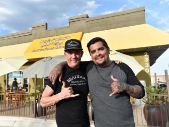 Braddah's Island Style owner Chris Campbell, left, and host Aaron Sanchez  stand outside Campbell's restaurant, home of the kahlua pig taco in Las Vegas, Nevada, as seen on Cooking Channel's Taco Trip, Season 2.