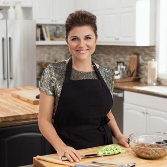 Host Tiffani Thiessen poses for a photo, as seen on Cooking Channel's Dinner at Tiffani's, Season 1.