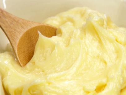 Whipped honey butter with a wooden spoon.