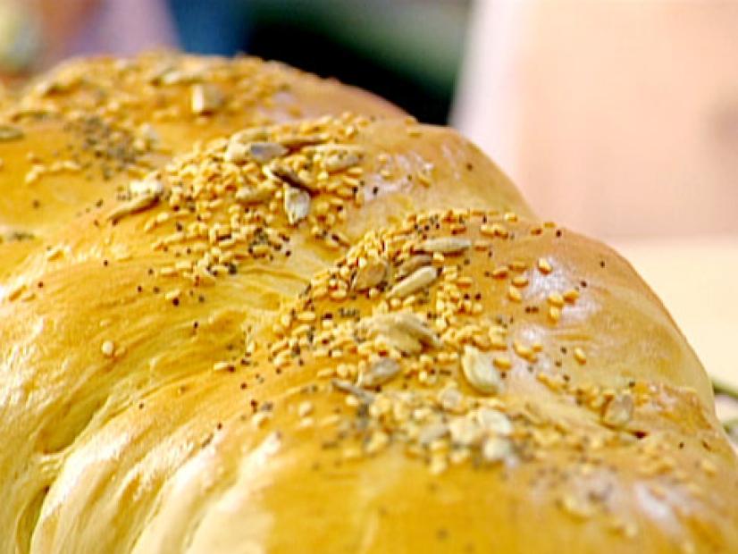 Baked white yeast bread has been sprinkled with sunflower seeds, sesame seeds, and poppy seeds.
