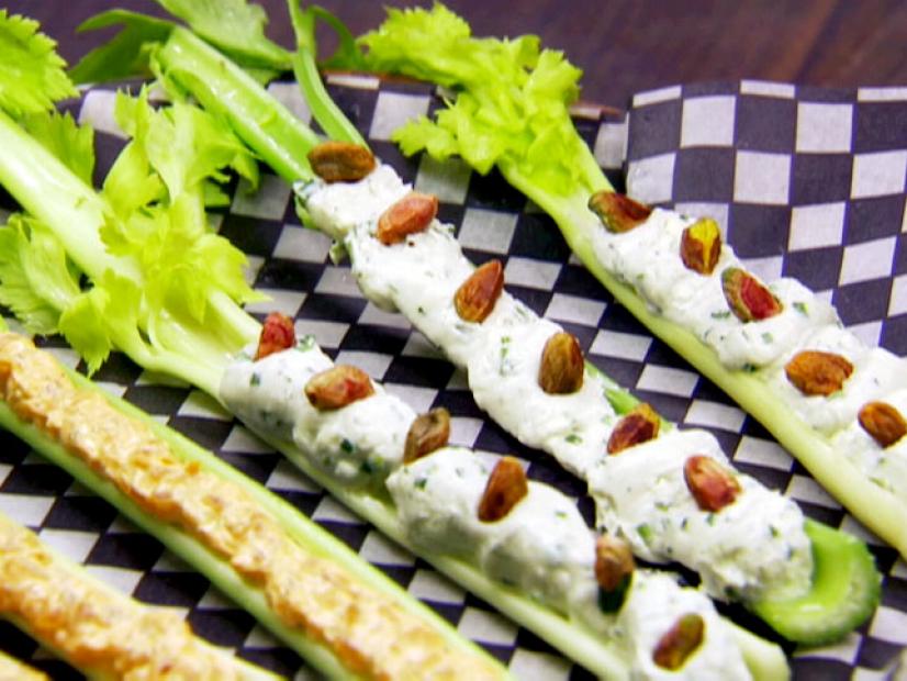 Celery stalks with leaves are stuffed with a caramelized onion spread and a blue cheese and pistachio spread.
