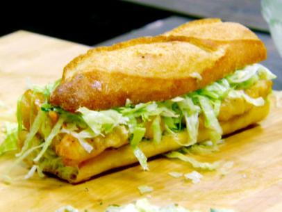 Fried haddock po boy on a baguette with julienned Iceberg lettuce.