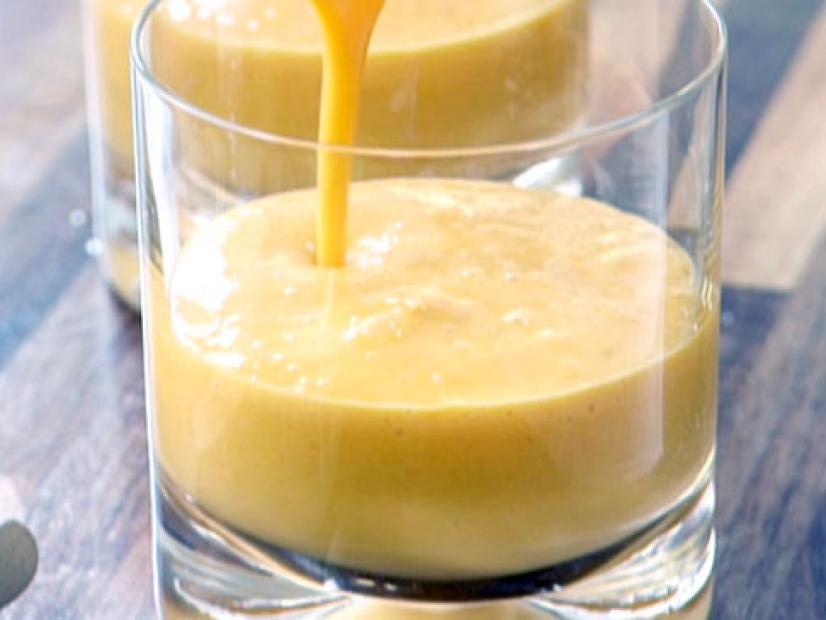 Mango smoothie is poured into a small glass.