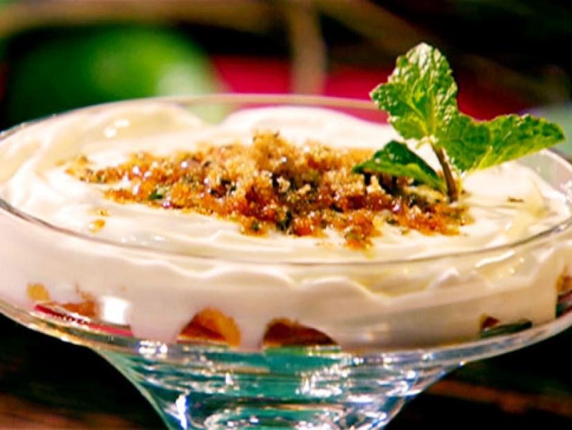 Yogurt topped with mint gremolata and garnished with fresh mint leaves.
