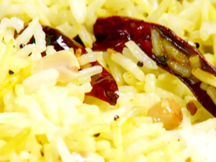 Lemon rice is made with basmati rice, whole dried red chillies, mustard seeds, and lentils.