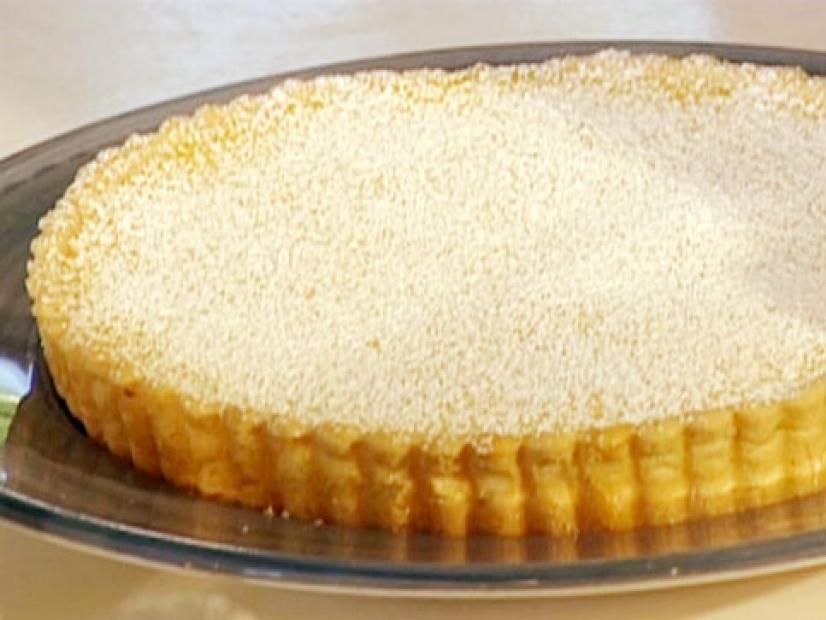 Lemon and passion fruit tart in a golden brown crust.