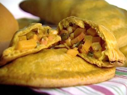 Sunny vegetable patties are pastries filled with yellow pepper, carrots, butternut squash, root ginger, coriander leaves, spring onions, sweet corn kernels, and double gloucester cheese.