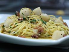 Cooking Channel serves up this Spaghetti with Bay Scallops, Guanciale and Parsley recipe from Michael Symon plus many other recipes at CookingChannelTV.com