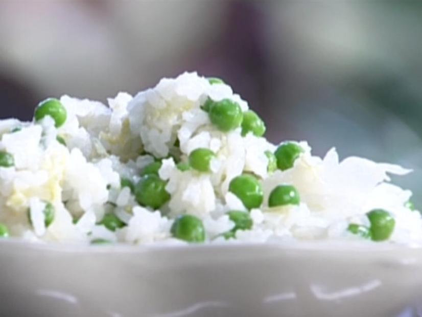 Baked Chinese rice with peas and ginger served in a white bowl.