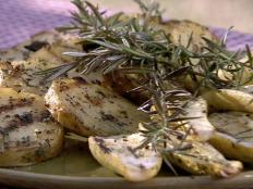 Cooking Channel serves up this Grilled Yukon Gold Potatoes with Thyme and Garlic recipe from Michael Chiarello plus many other recipes at CookingChannelTV.com