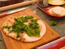 Cooking Channel serves up this Speck and Mustard Greens Pizza recipe from Debi Mazar and Gabriele Corcos plus many other recipes at CookingChannelTV.com