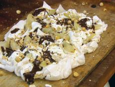 Cooking Channel serves up this Tray-Baked Meringue with Pears, Cream, Toasted Hazelnuts and Chocolate Sauce recipe from Jamie Oliver plus many other recipes at CookingChannelTV.com