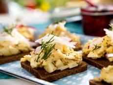 Cooking Channel serves up this Open-Faced Egg Salad Tea Sandwiches with Crab and Poppy Seeds on Pumpernickel recipe from Bobby Flay plus many other recipes at CookingChannelTV.com