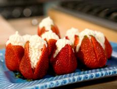 Cooking Channel serves up this Strawberries Filled with "Clotted" Cream recipe from Bobby Flay plus many other recipes at CookingChannelTV.com