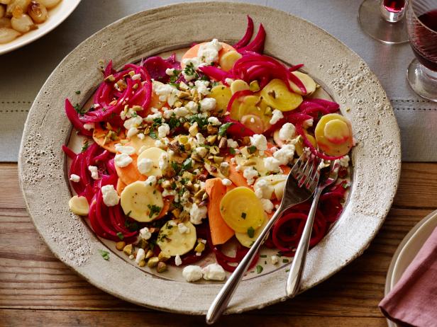 PICKLED ROOT VEGETABLE SALAD
Kelsey Nixon
Cooking Channel
Golden Beets, Parsnip, Sweet Potato, Red Beets, Red Onion, Apple Cider Vinegar,
Sugar, Kosher Salt, Mustard Seeds, Celery Seed, Whole Black Peppercorns, Garlic, Goat
Cheese, Flatleaf
Parsley, Pistachios, Olive Oil, Mandolin Slicer