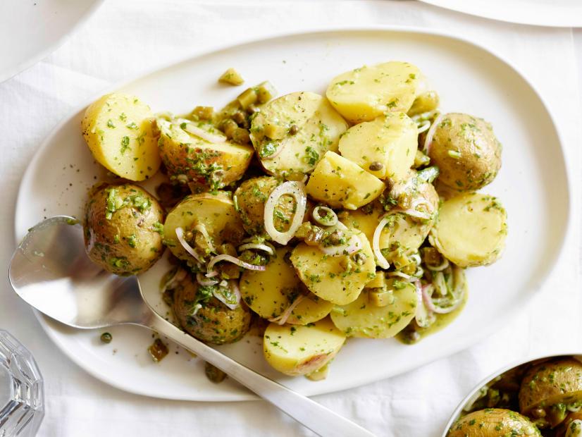 Baked potato salad is made with Yukon gold potatoes, parsley, basil, shallots, and dijon mustard along with other herbs.