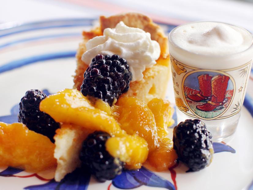 Elizabeth Karmel's Whiskey Buttermilk Pie with Fresh Whipped Cream and Tipsy Berries and Peaches and Texas Tequila Milkshake as she and Roger Mooking cook at the Michelson home in Lockhart, TX, as seen on Cooking Channel's Red, White, and Grill special featuring Williams-Sonoma.