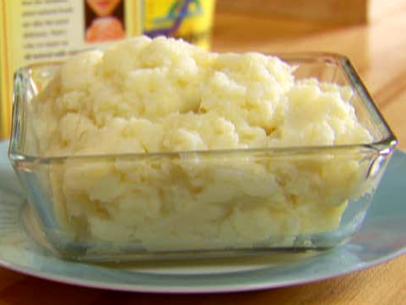 A casserole dish filled with miracle mashies is not just mashed potatoes but also mashed cauliflower.