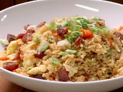 Fried rice with Chinese sausage is topped with finely diced carrots, celery, and scallions.
