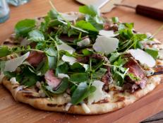 Get a pizza on the grill recipe and tips for grilled pizza at home from Cooking Channel chefs Bobby Flay and Kelsey Nixon.