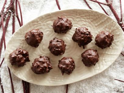 Alton brown coats the coconut balls with chocolate. 