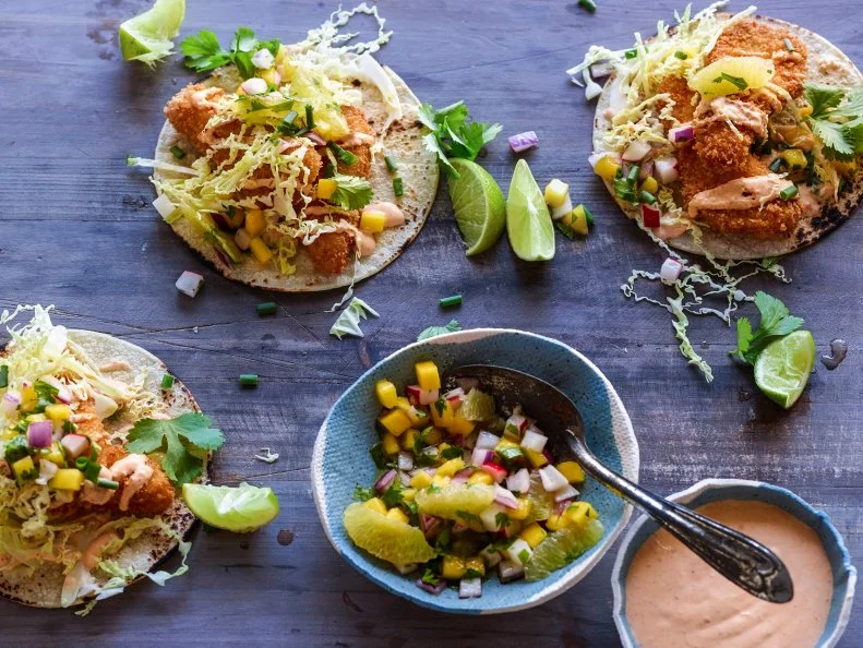 Fish tacos are served with radish mango salsa.