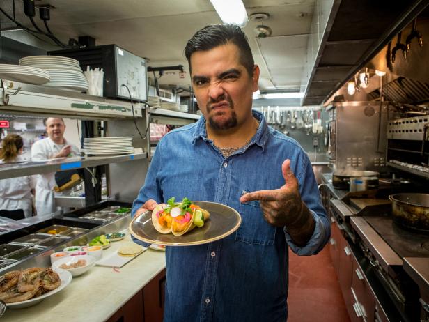 Chef Aaron Sanchez with his signature Crispy Gulf Shrimp tacos with fresh Louisiana Gulf shrimp, chili mayo, cilantro, and pickled vegetables on a corn tortilla, one of the dishes on the menu at Johnny Sanchez, a taqueria in New Orleans, a collaboration between chefs Aaron Sanchez and John Besh as seen on Cooking Channel’s Taco Trip, Season 1.