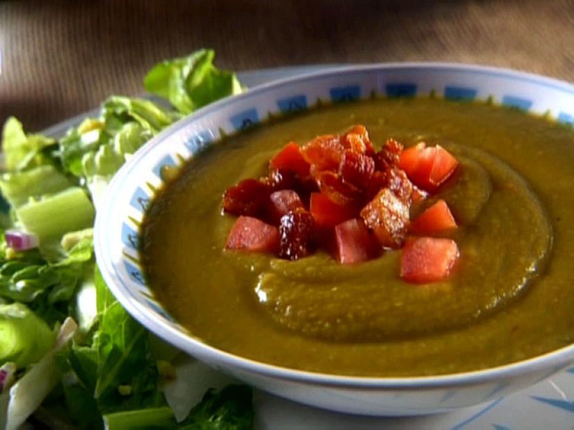 A Bowl of Split Pea Soup topped with diced tomatoes and bacon