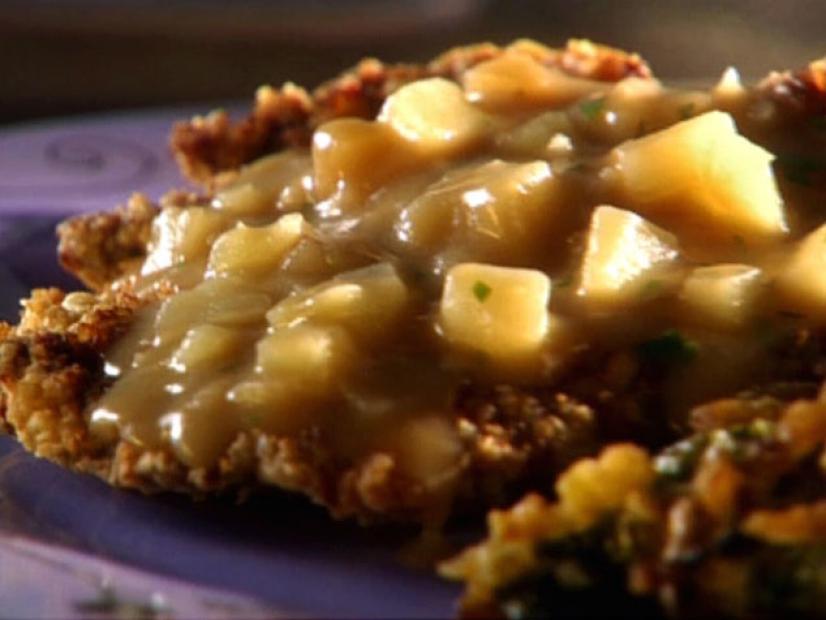 Crusted Cube Steak topped with diced potato gravy
