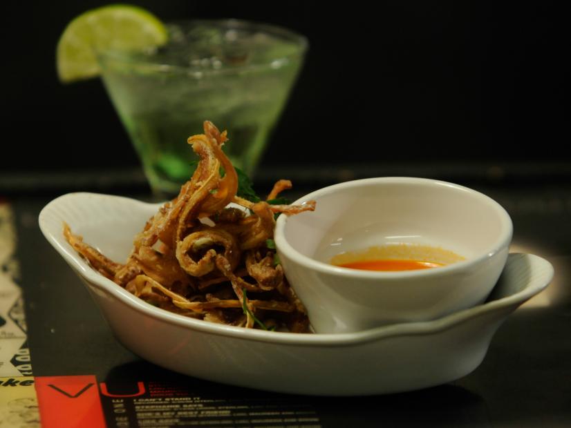 Fried Pig Ears with house made hot sauce plated at the "Foggy Notion", a bar in Portland, Oregon as seen on Cooking Channel's Belly Up, Season 1.