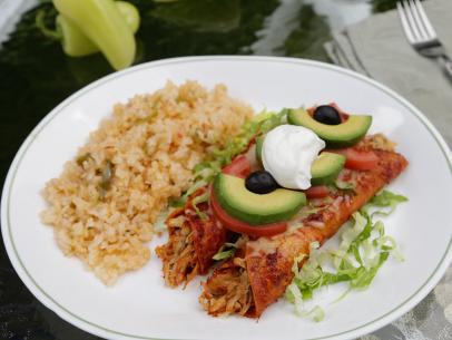 Enchilada dish with rice are featured food for Olga and Carlos Gonzalez’s backyard party, as seen on Cooking Channel’s My Grandmother’s Ravioli, Season 3.