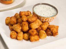 Get Cooking Channel's easy tater tot recipes for casseroles, loaded baked potato, nachos, poutine and more.