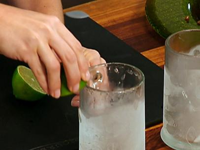 A lime is rubbed around the rim of a frosted mug.