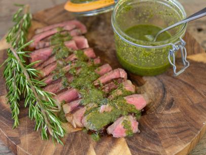 Bob's Chimichurri Sauce covers slices of beef cut from tomahawk steaks, as seen on UpRooted with Sarah Sharratt.