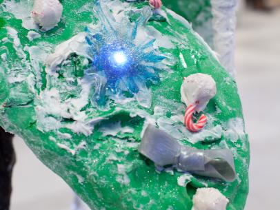 A detail of the yellow team's creation for Santa's Mega Challenge: Ultimate Christmas Lights, depicting animals bringing the Holiday spirit with a tree lighting ceremony for the woodland creatures, as seen on Food Network's Cake Wars, Christmas Special.