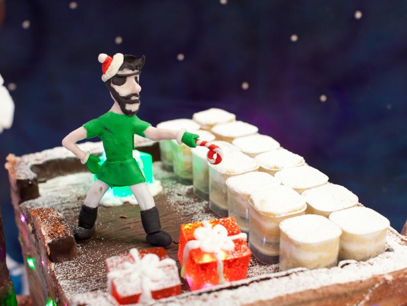 A detail from the navy team's creation for Santa's Mega Challenge: Ultimate Christmas Lights, depicting a high seas holiday featuring a festively lit pirate ship, as seen on Food Network's Cake Wars, Christmas Special.