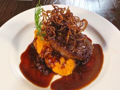 Cuvee 30A New Zealand Venison Steak, Pan Seared, Red Wine Tomato Basil Reduction Sauce, Mashed Sweet Potatoes and Tobacco Onions