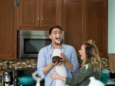 With his face covered in frosting, Jonathan Bennett licks his chin as host Haylie Duff laughs at Sugar Cat Studio in Santa Barbara, CA as seen on the Cooking Channel's Haylie's America episode 101.