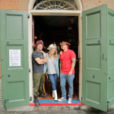 Portrait shot of host Haylie Duff, Jimmy Ruggiero, and Keith Kurtz wear decorative pirate hats in the doorway of the Pirate's Alley Cafe in New Orleans, LA as seen on the Cooking Channel's Haylie's America episode 104.