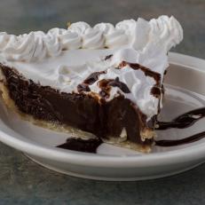 The Slap Yo Mama Chocolate Pie from The Pie Folks in Cordova, Tennessee, features a shortening crust cradling a fudgy filling that’s tucked under a fluffy blanket of whipped cream.