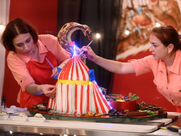 Contestant Tatiana Kovalenko and her assistant Tonya Frankiv race to finish their Snake Charmer cake, as seen on Freakshow Cakes, Season 1.