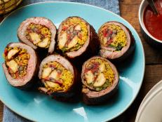 This rolled flank steak is stuffed with all the flavors of Puerto Rico. Sweet plantains, yellow rice and black beans bring the essence of the island, while the roasted garlic seasoning and barbecue sauce amp up the flavor.
